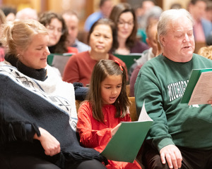 Families singing at Mass